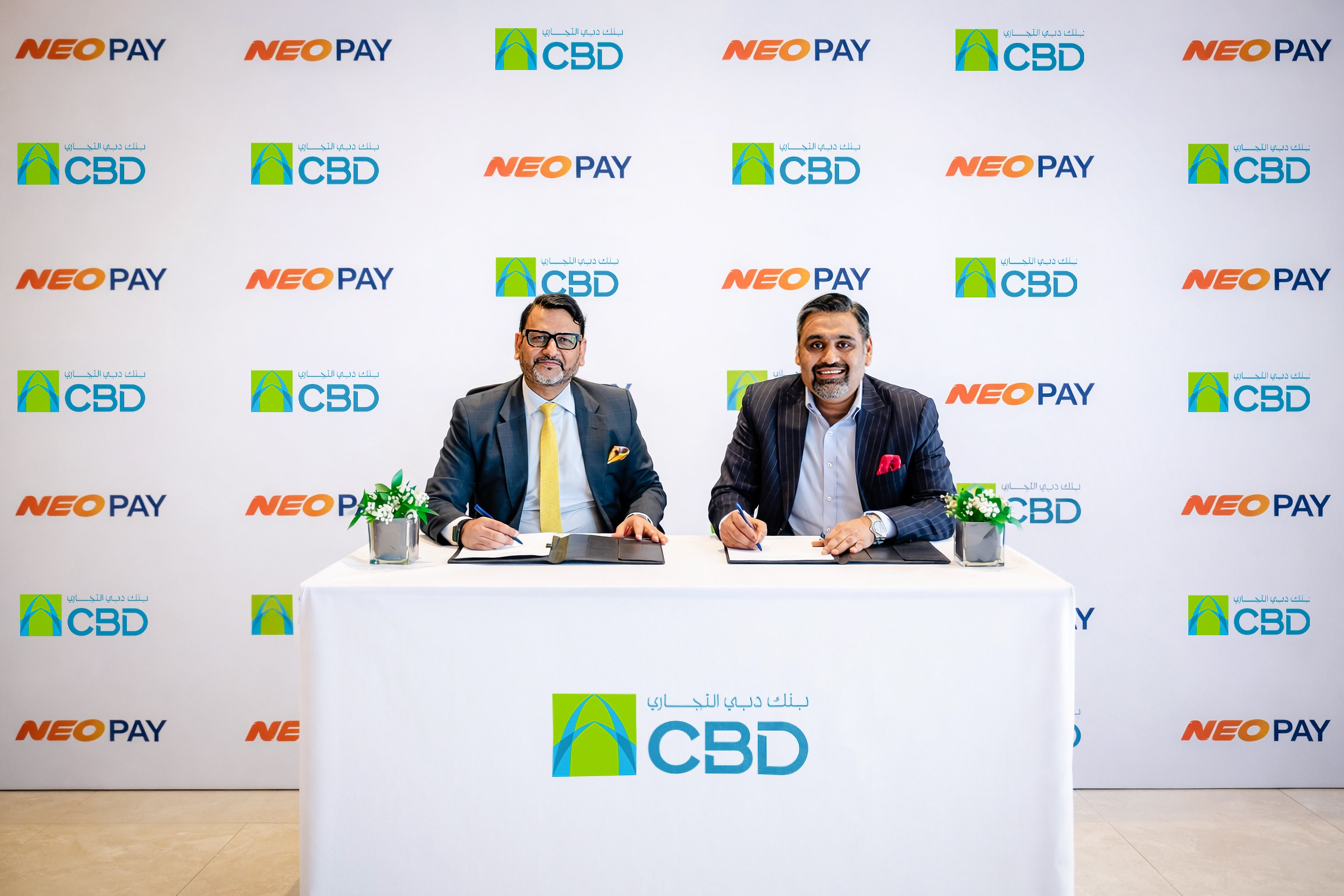 Commercial Bank of Dubai and NEOPAY representatives signing their partnership agreement